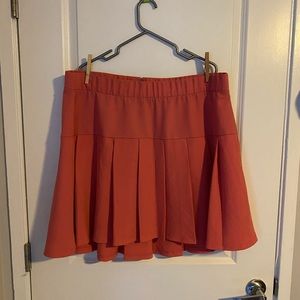 Bright pink pleated high-low mini skirt